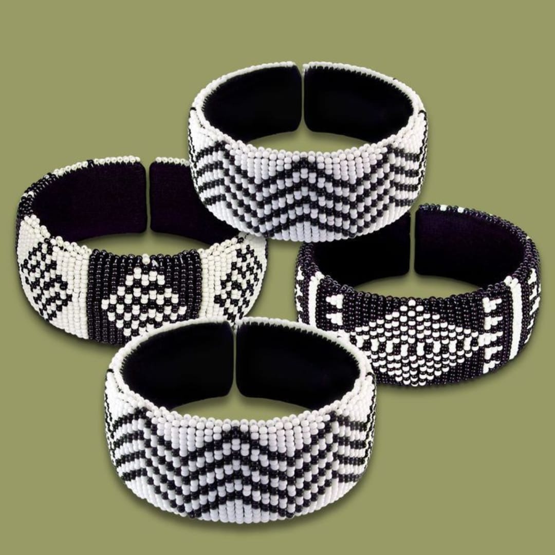 A set of 4 black and white bracelet bangles