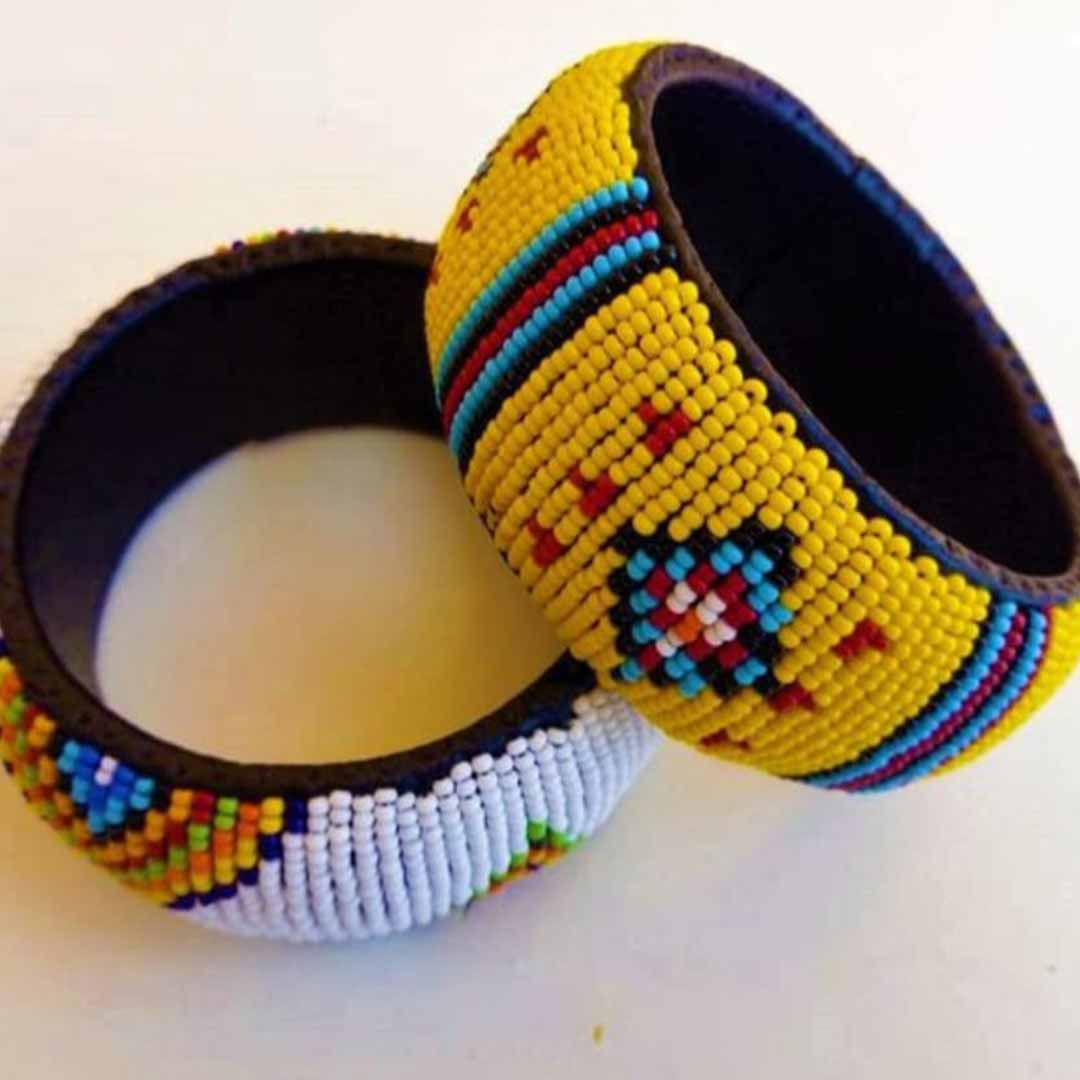 A pair of yellow and white beaded leather bangles