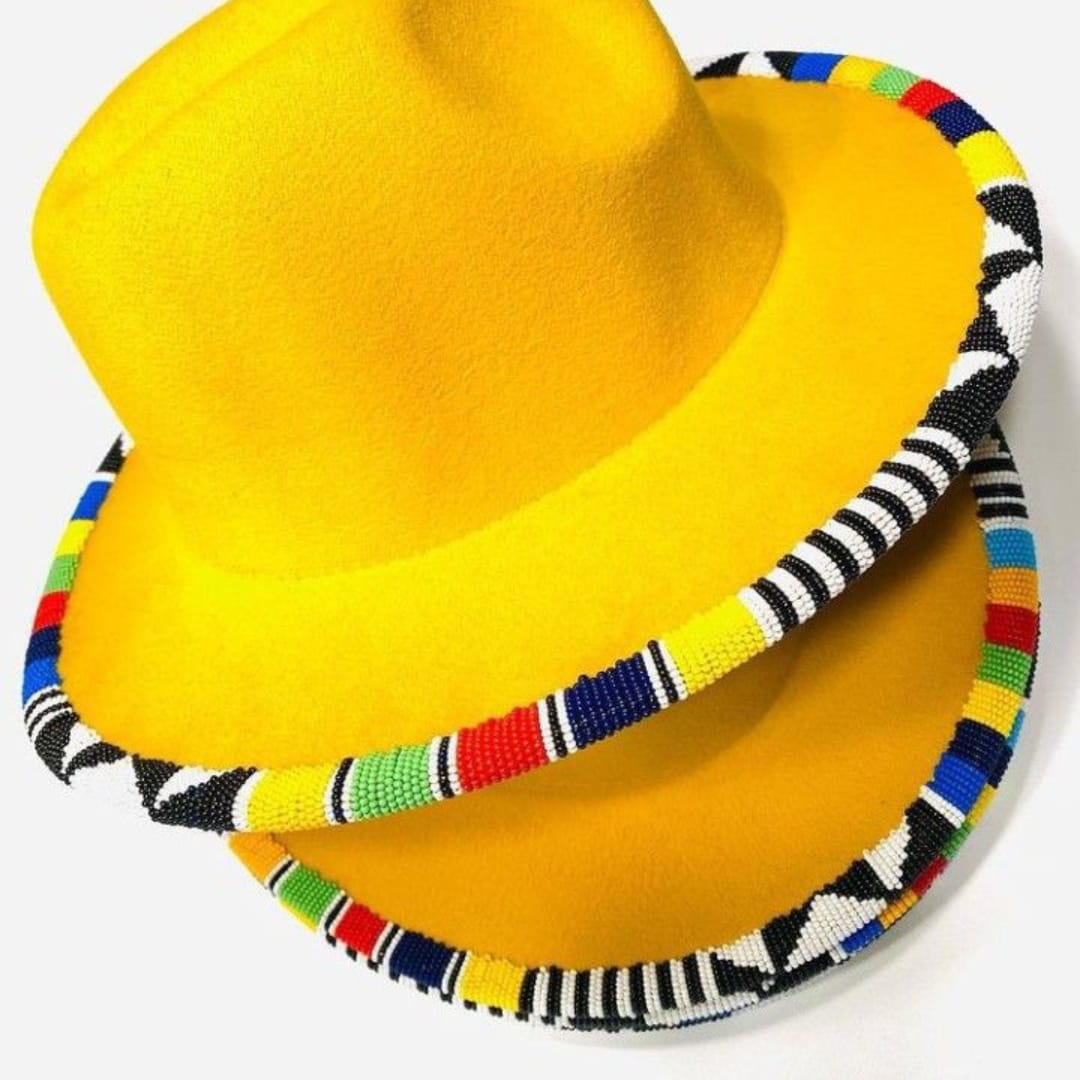 2 yellow Fedora hats with beaded decorations